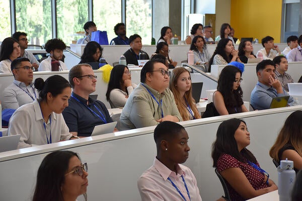 Students sitting in room 205 listening to a speaker
