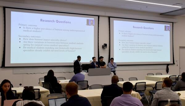 students presenting at dean's research day in 2024