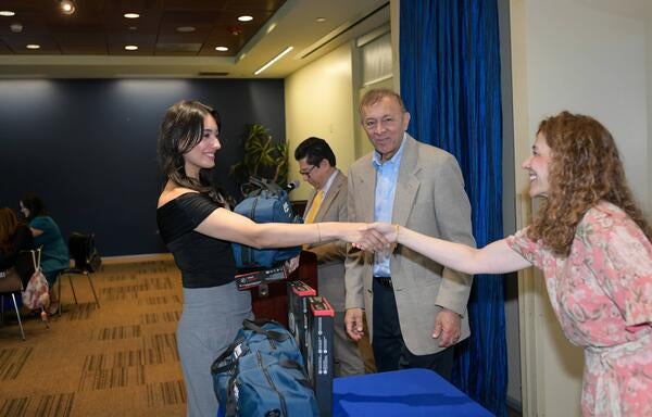 Salma Haider shaking hands as Thomas Haider looks on