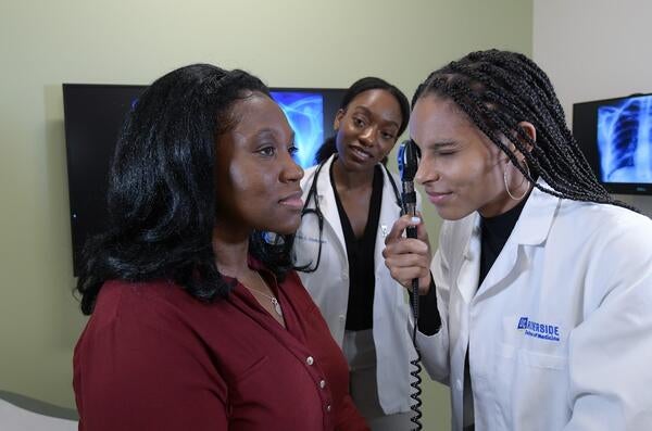 Students working with a standardized patient