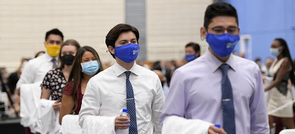 Medical students walking in the White Coat Ceremony